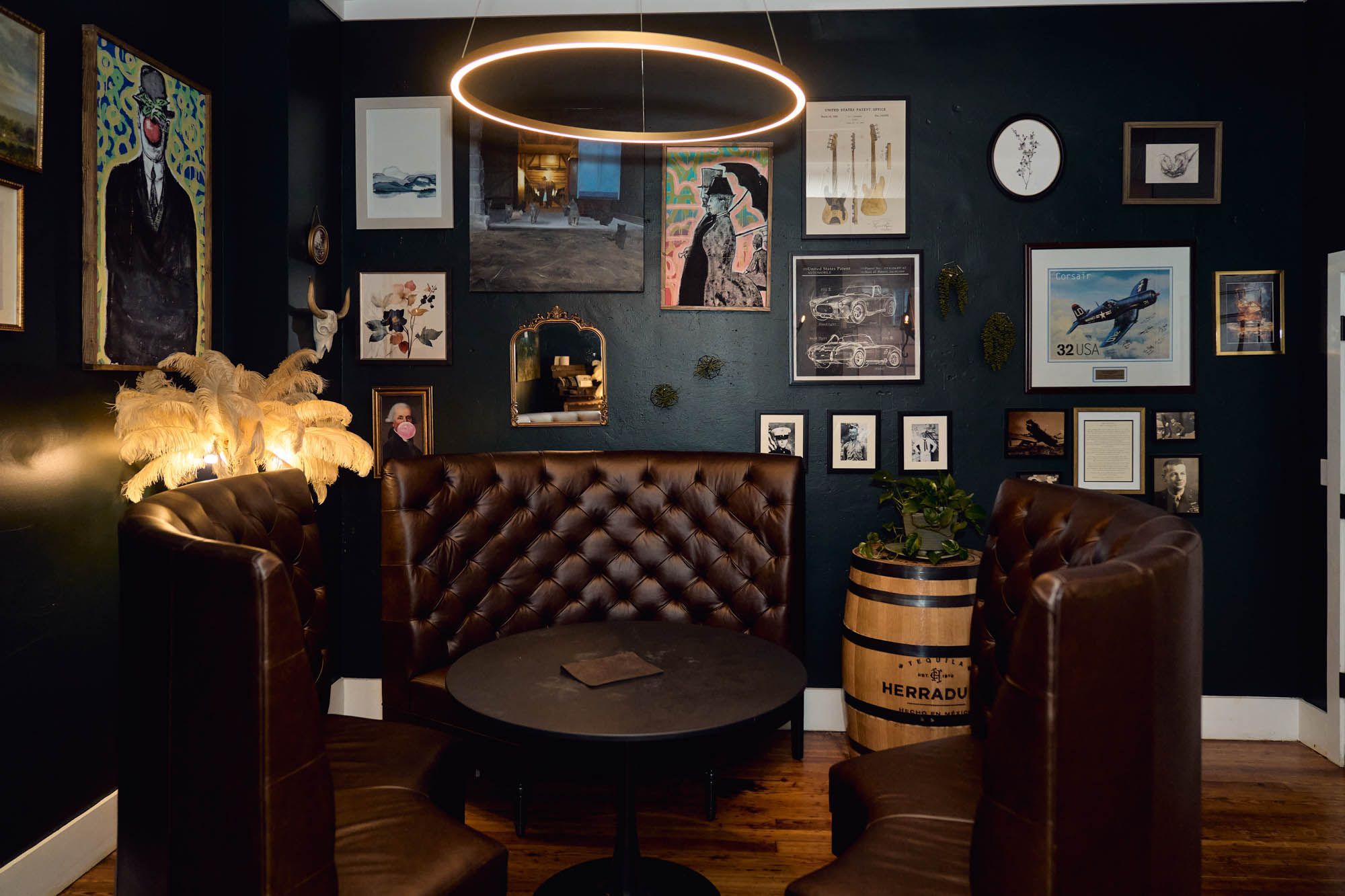 Tables, upholstered seats, lights, and frames on the wall.