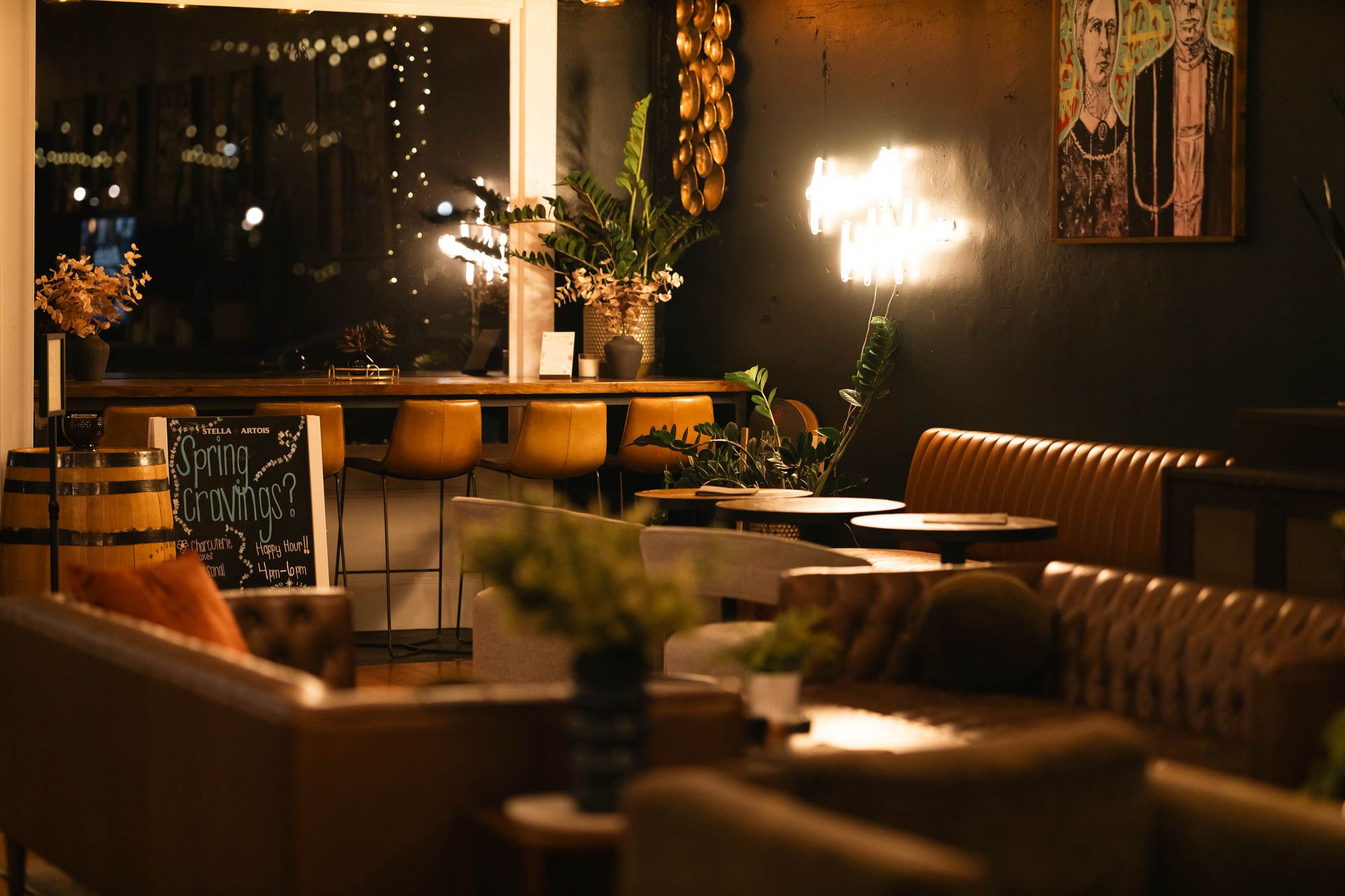Interior, seating area, sofas and armchairs, high seating in the back by the shop window.